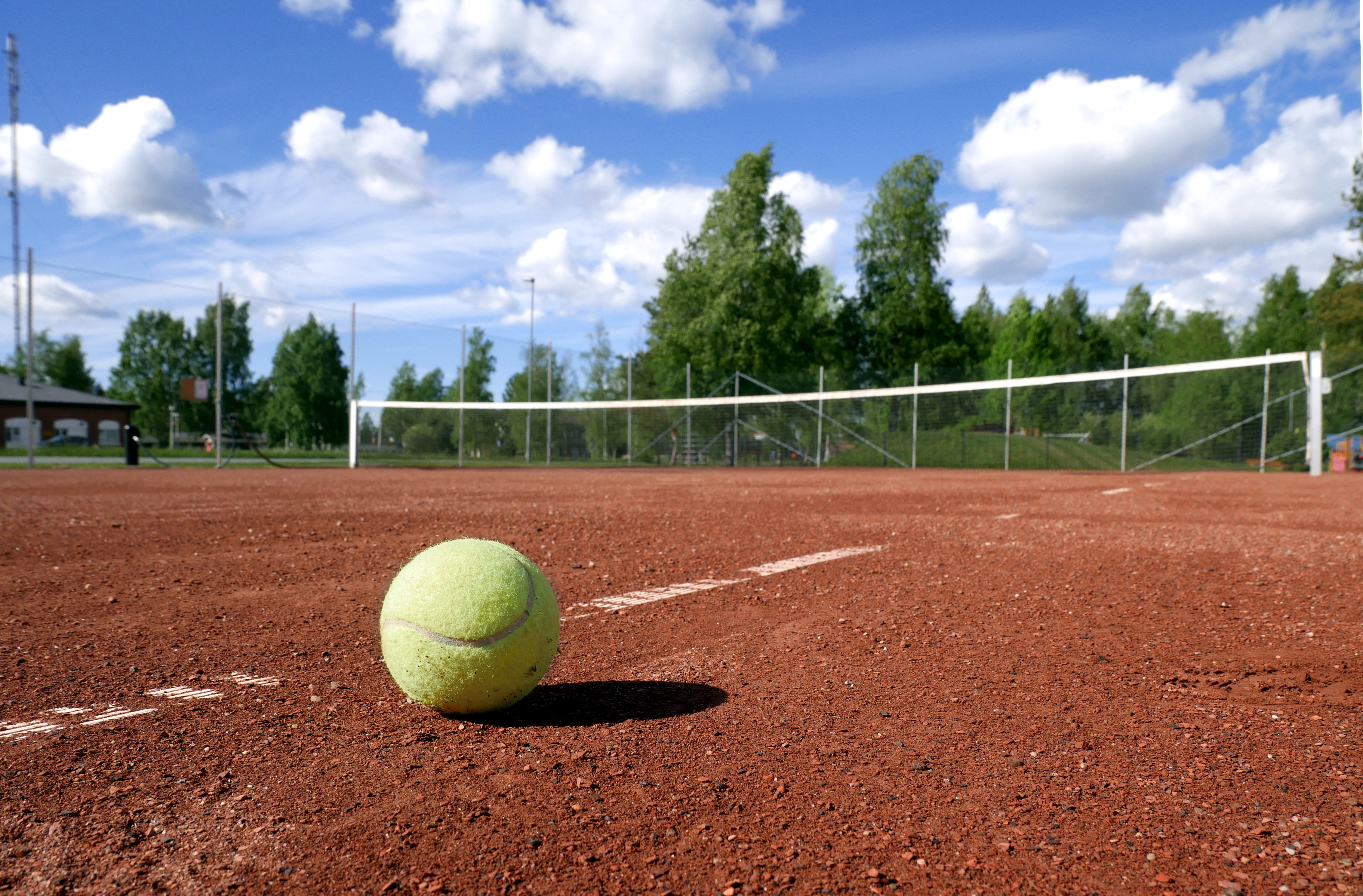 image of tennis ball on court